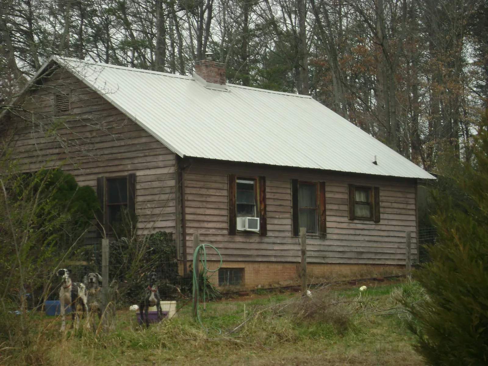 White metal roof on an old wood sided farmhouse, from a Metal Roof Installation job in Bridgton